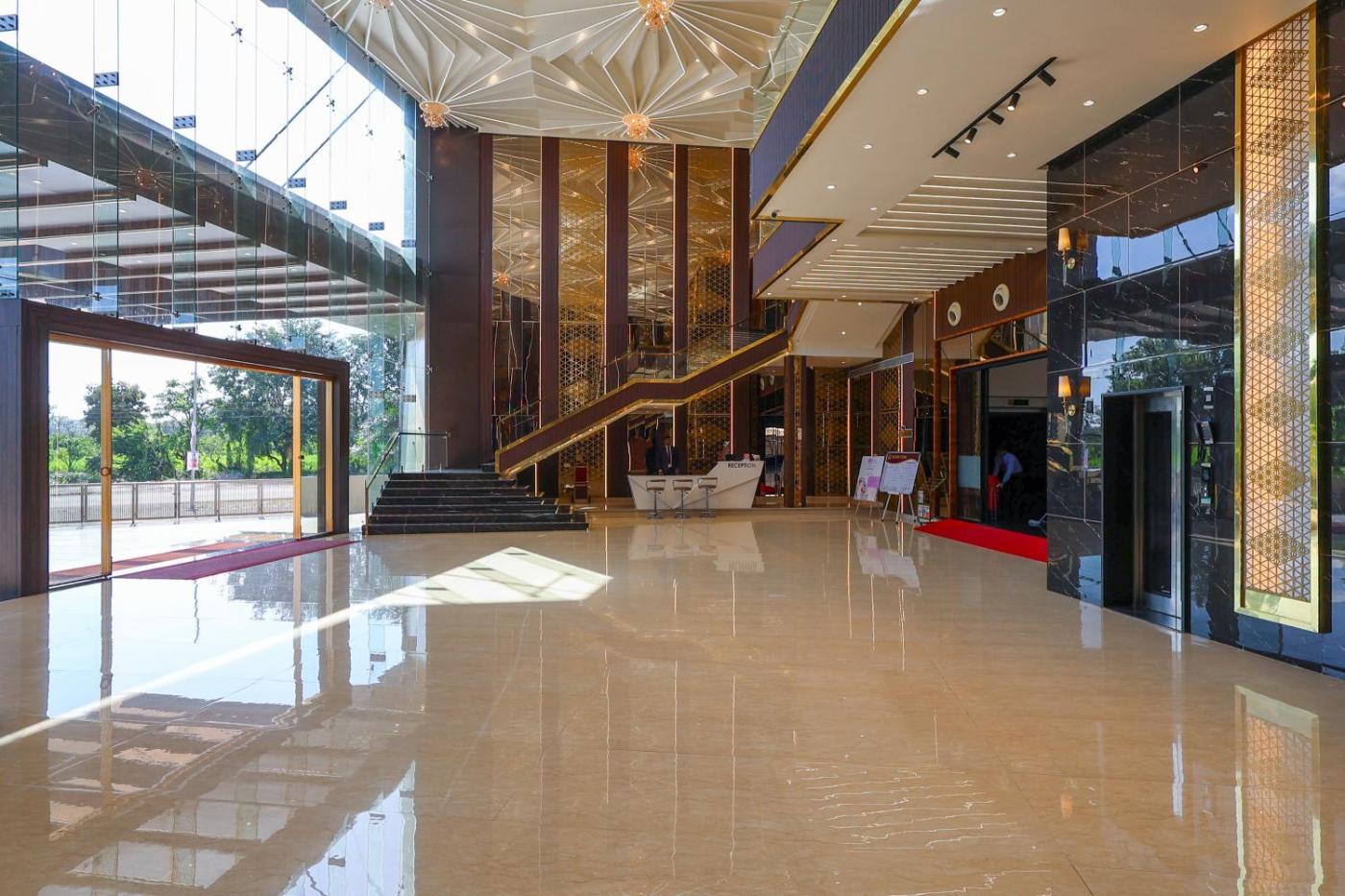 Grand ground-floor entrance with staircase and marble floors at Silver Star, Amravati