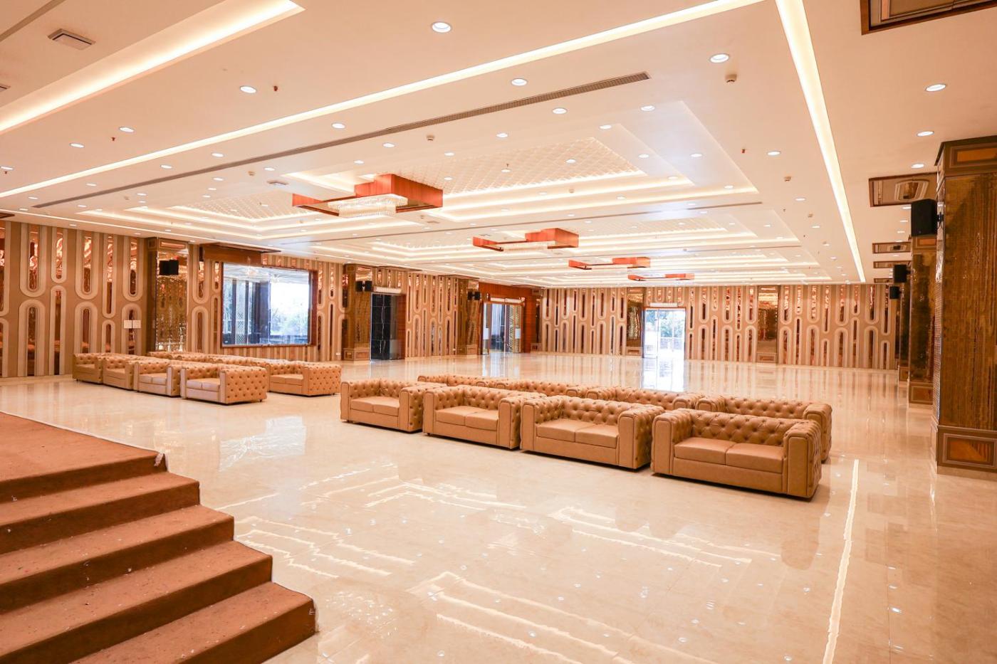 Banquet hall with tufted lounge seating and designer ceiling at Silver Star, Amravati
